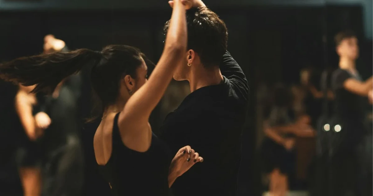 Couples dancing at a Buenos Aires milonga, a social tango night where nobody is performing