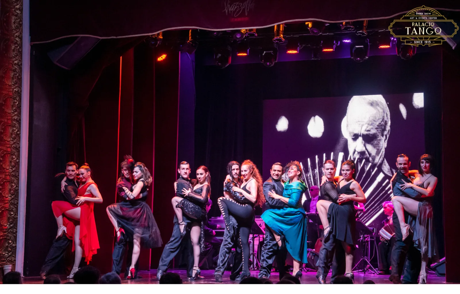 The full Piazzolla Tango company on stage in bright costume at the end of a number