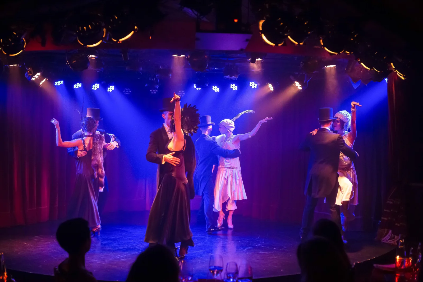 Rojo Tango dancers performing under purple and blue lighting in the Faena Hotel cabaret