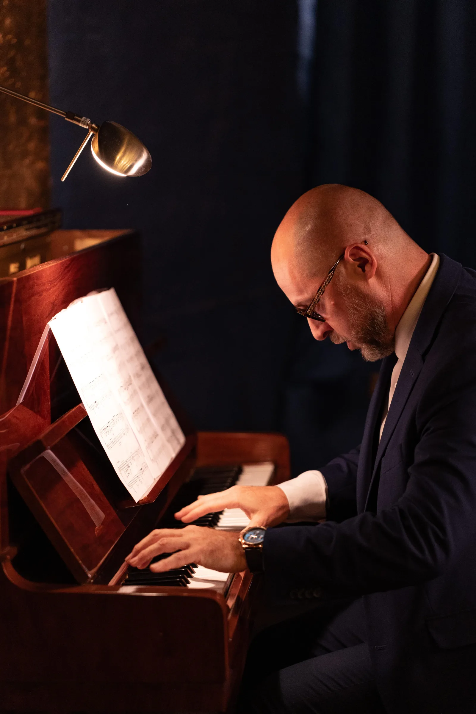 A pianist playing at the upright piano during a Secreto Tango performance