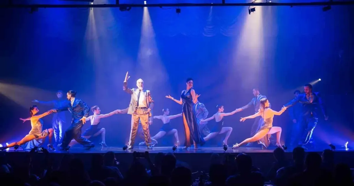 The Madero Tango company on stage under blue spotlights during the Magia! production in Puerto Madero